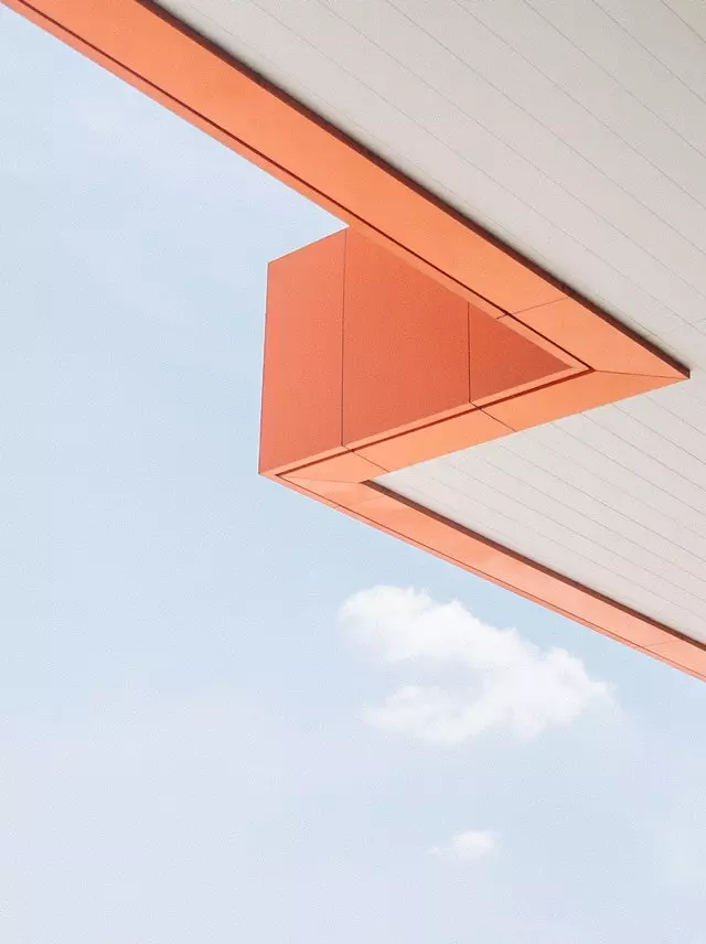 Angled orange roof with sky in background