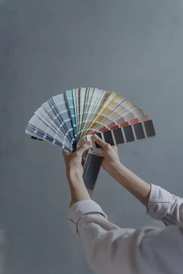 Woman holding rainbow colour chart