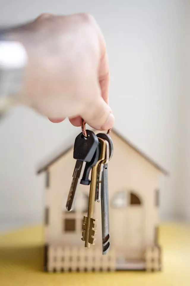 Landlord hand holding out keys to give to new property owner